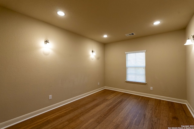 unfurnished room with wood-type flooring