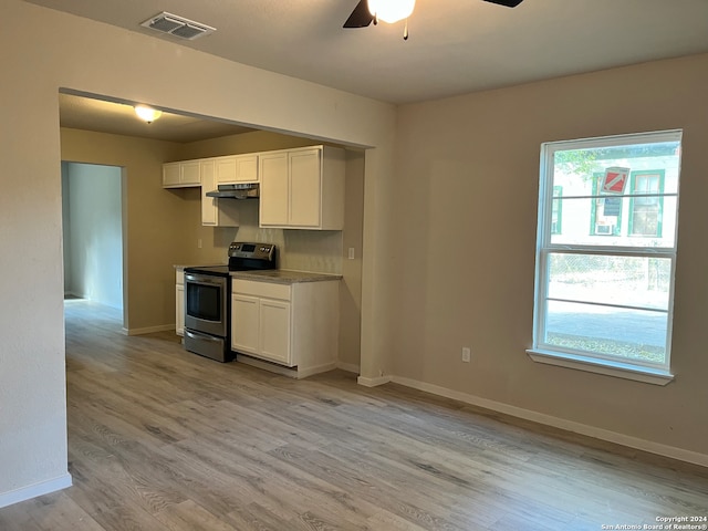 kitchen featuring electric range, white cabinets, light hardwood / wood-style floors, and ceiling fan