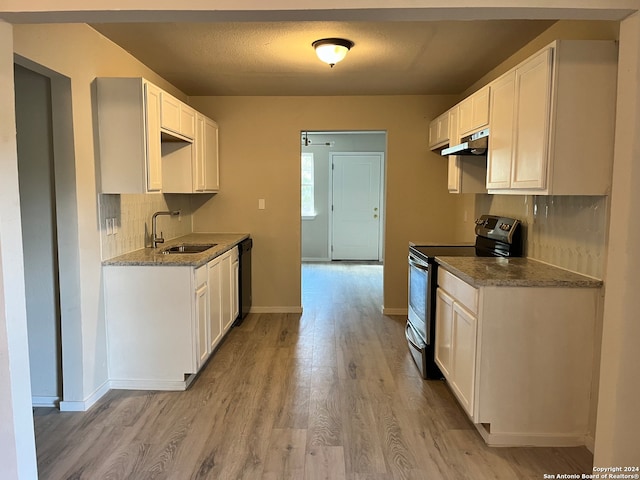 kitchen with stainless steel electric range, dishwasher, sink, light hardwood / wood-style flooring, and white cabinetry