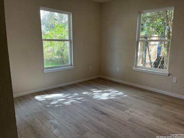 spare room with light hardwood / wood-style flooring