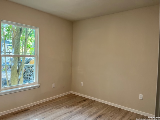 unfurnished room with light hardwood / wood-style flooring