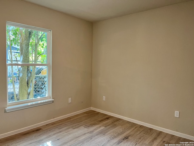 unfurnished room with light hardwood / wood-style flooring