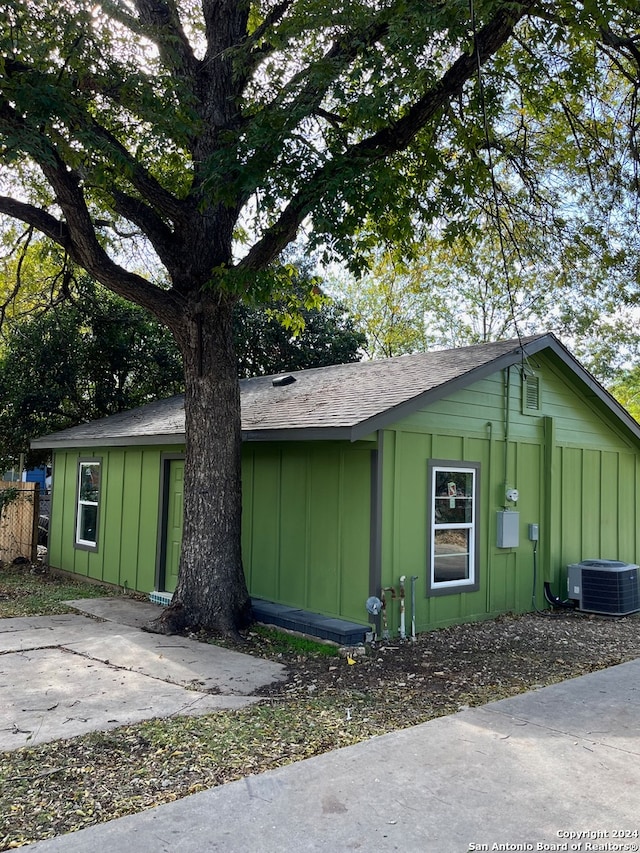 view of side of property featuring central air condition unit and a patio area