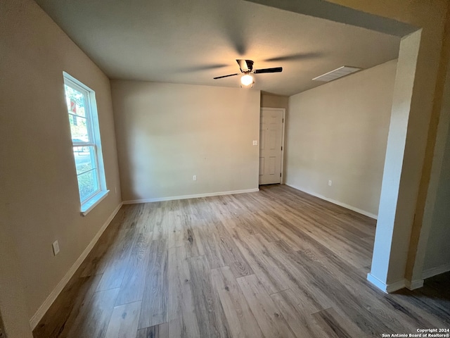 empty room with light hardwood / wood-style flooring and ceiling fan