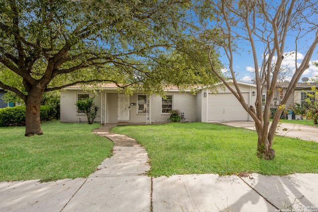 single story home featuring a garage and a front lawn