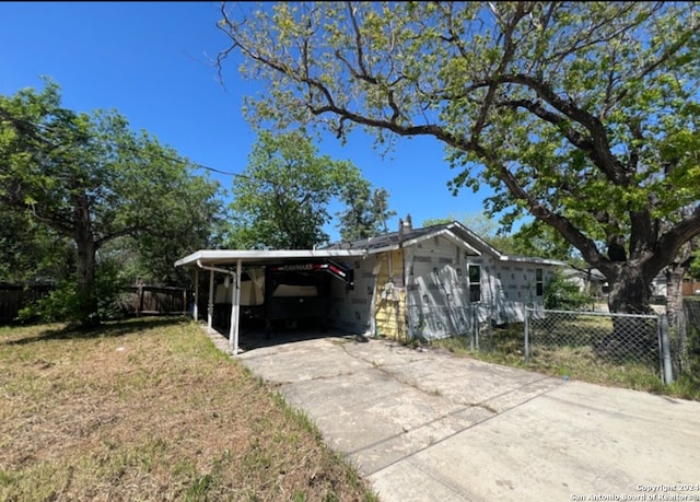 view of side of home with a carport