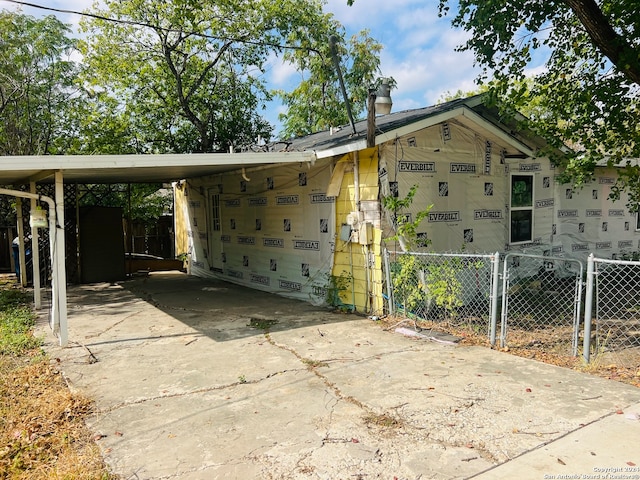 view of property exterior with a carport