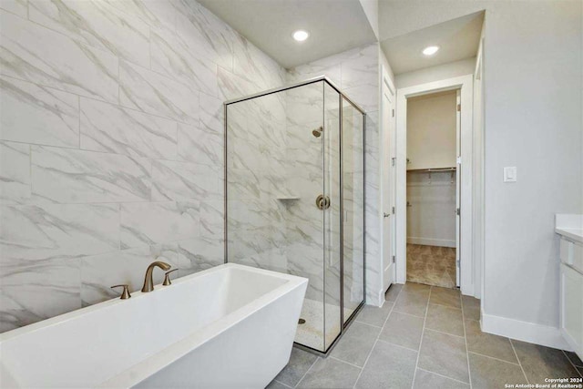 bathroom with vanity, independent shower and bath, and tile patterned flooring