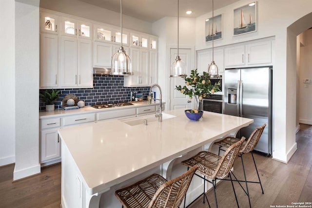 kitchen featuring sink, a center island with sink, white cabinets, and appliances with stainless steel finishes