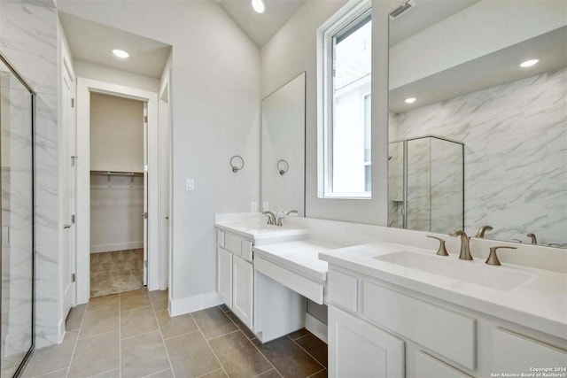 bathroom featuring walk in shower, a healthy amount of sunlight, and vanity