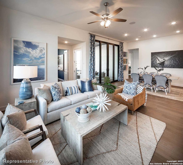 living room with dark wood-type flooring and ceiling fan