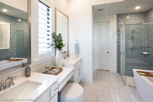 bathroom featuring vanity, a shower with door, and wood-type flooring