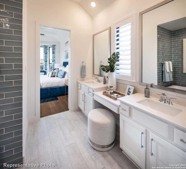 bathroom featuring vanity and lofted ceiling