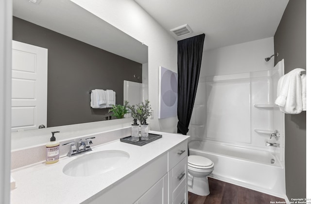 full bathroom featuring vanity, wood-type flooring, shower / tub combo, and toilet