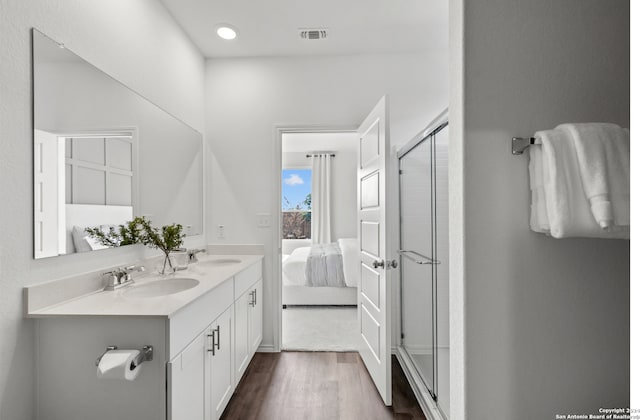 bathroom featuring vanity, wood-type flooring, and walk in shower