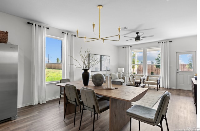 8156 Smithers Ave, San Antonio, TX 78252 - dining space featuring plenty of natural light, wood finished floors, ceiling fan, and a chandelier