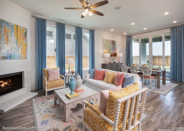 living room with hardwood / wood-style floors, a fireplace, and ceiling fan