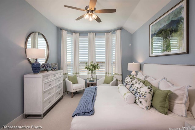 bedroom featuring light carpet, ceiling fan, vaulted ceiling, and multiple windows