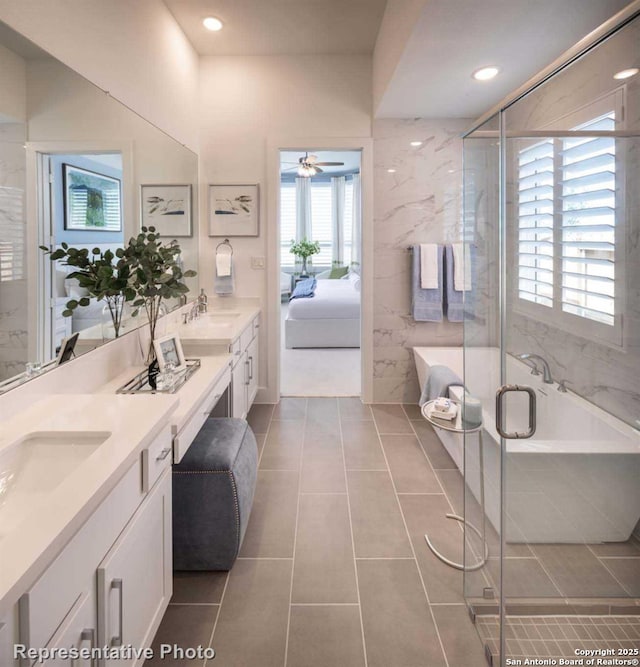 bathroom with ceiling fan, vanity, an enclosed shower, and tile patterned flooring