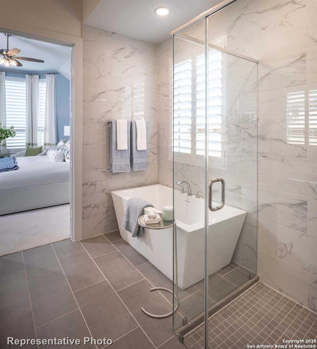 bathroom featuring plus walk in shower, tile walls, tile patterned floors, and ceiling fan