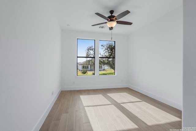 unfurnished room with ceiling fan and light hardwood / wood-style flooring