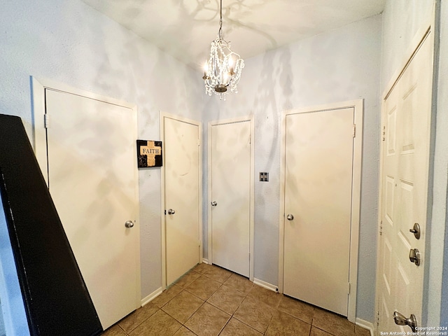 interior space with a notable chandelier and light tile patterned floors