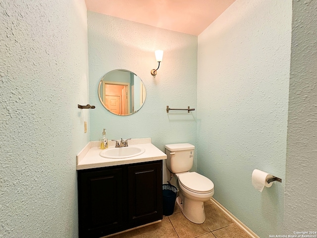 bathroom featuring tile patterned flooring, vanity, and toilet