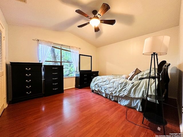 bedroom with ceiling fan, dark hardwood / wood-style floors, and lofted ceiling