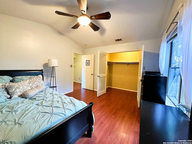 bedroom featuring ceiling fan, dark hardwood / wood-style floors, lofted ceiling, and a closet