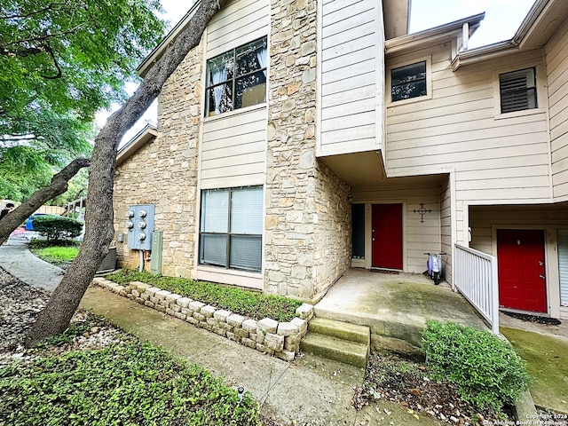 doorway to property featuring stone siding