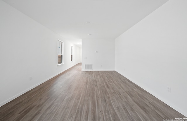 spare room with dark hardwood / wood-style floors