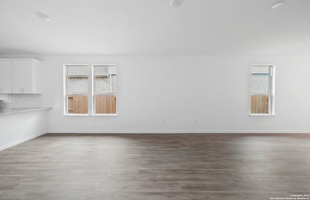 unfurnished room with hardwood / wood-style flooring