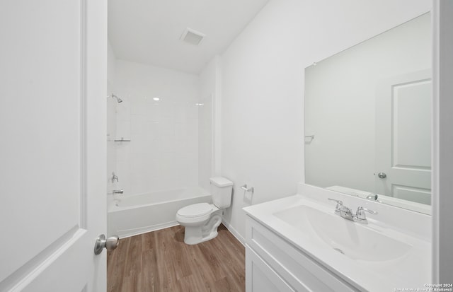 full bathroom featuring hardwood / wood-style floors, vanity, toilet, and shower / washtub combination