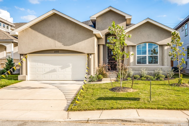 view of front of property featuring a front yard and a garage