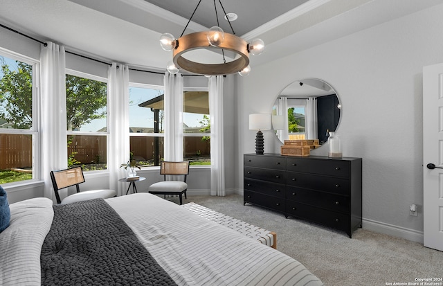 carpeted bedroom featuring multiple windows, crown molding, and a chandelier