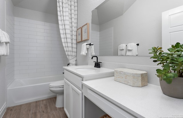 full bathroom featuring shower / bath combination with curtain, vanity, wood-type flooring, and toilet