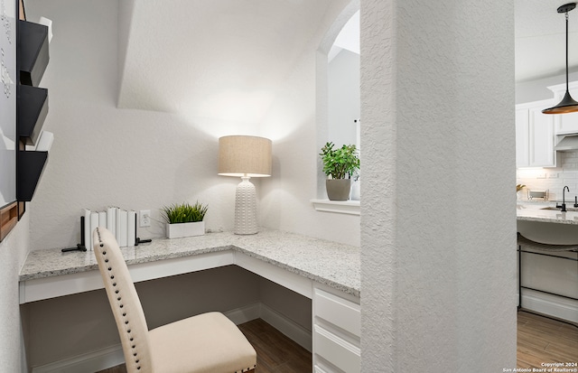 office with sink, built in desk, and light hardwood / wood-style floors