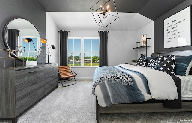 bedroom with an inviting chandelier, carpet floors, and multiple windows