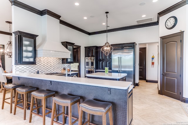 kitchen with premium range hood, kitchen peninsula, a breakfast bar area, and appliances with stainless steel finishes