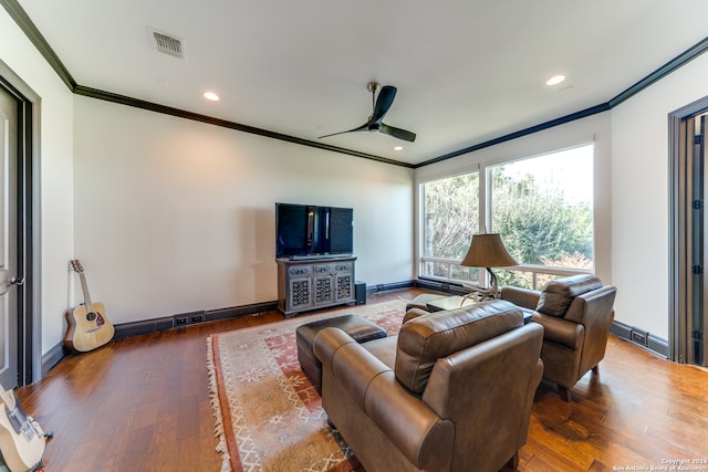 living room with dark hardwood / wood-style floors, ceiling fan, and ornamental molding