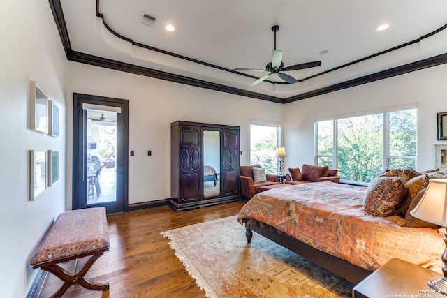 bedroom with crown molding, ceiling fan, access to exterior, a tray ceiling, and dark hardwood / wood-style flooring