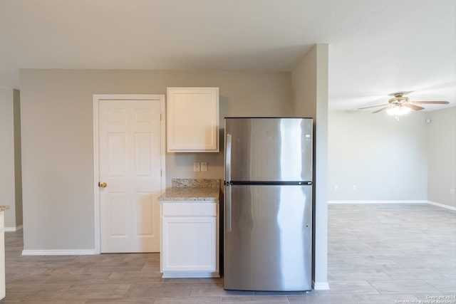 kitchen featuring white cabinetry, stainless steel fridge, and ceiling fan