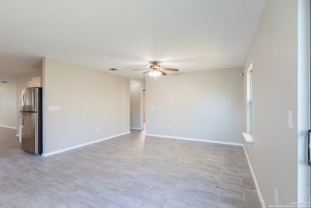 unfurnished room featuring light wood-type flooring and ceiling fan