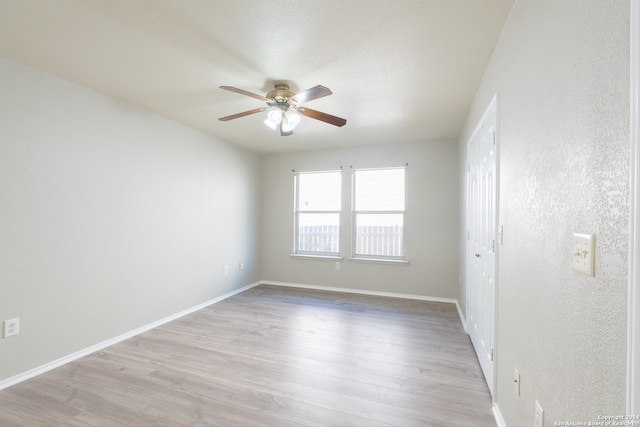 spare room featuring ceiling fan and light hardwood / wood-style floors