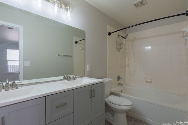 full bathroom featuring toilet, vanity, and tiled shower / bath combo