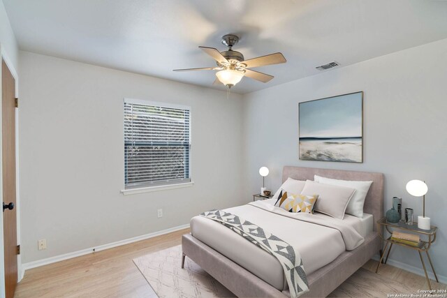 bedroom with ceiling fan and light wood-type flooring