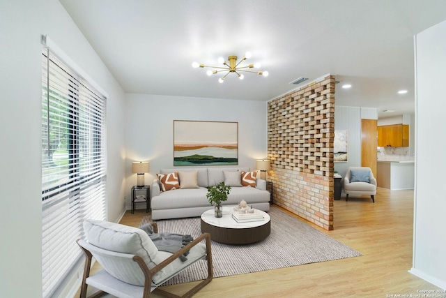 living room featuring a notable chandelier and light hardwood / wood-style floors