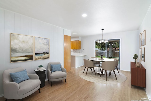 dining room with an inviting chandelier and light hardwood / wood-style flooring