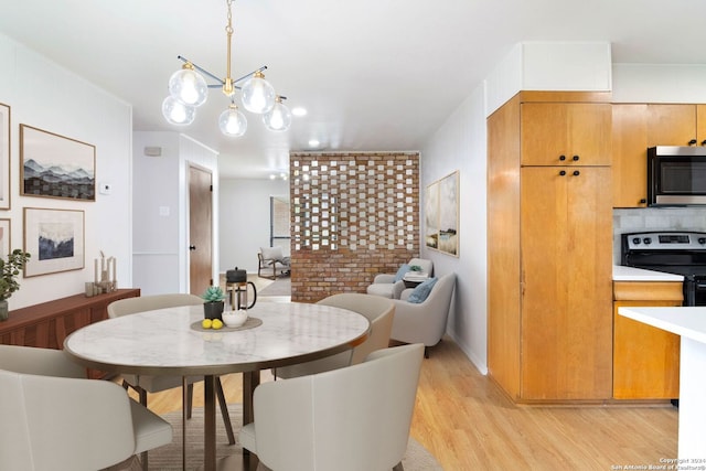 dining room featuring light hardwood / wood-style floors and a chandelier