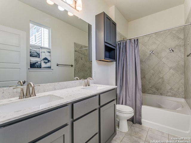 full bathroom featuring tile patterned floors, vanity, toilet, and shower / bath combo with shower curtain